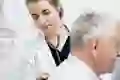 A doctor listens to a patient’s lungs