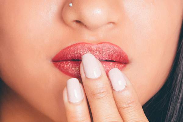 女人用手指触摸嘴唇