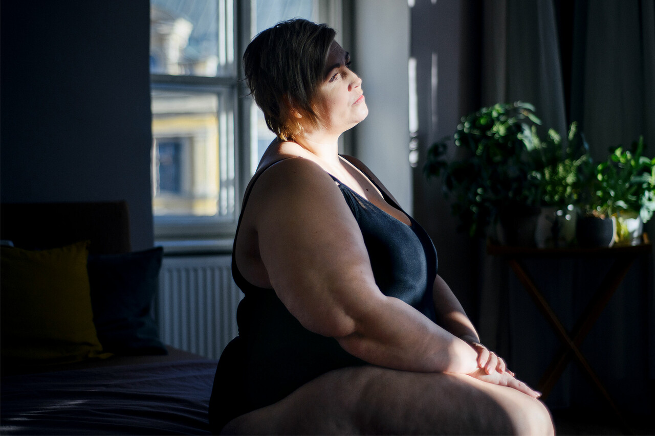 一个肥胖的女人看着窗外