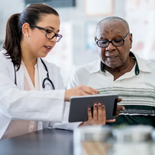 Doctor talking to senior male patient.