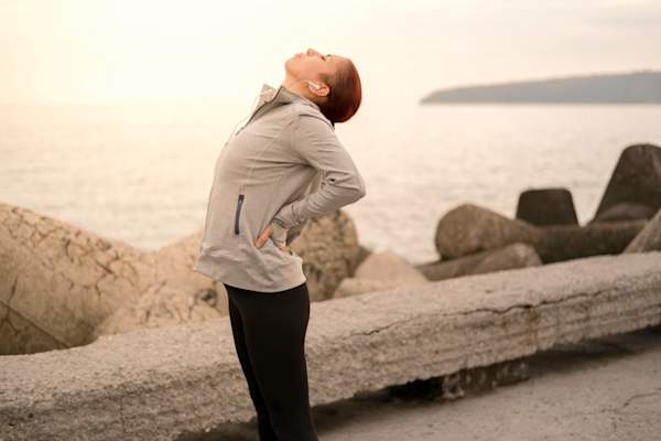 woman arching back in pain