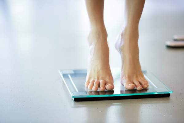 woman standing on scale