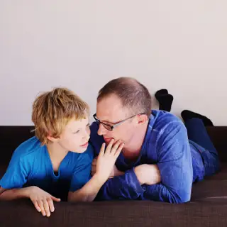 father playing with son with autism image