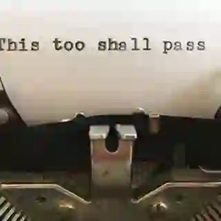 "This too shall pass" written on a typewriter.