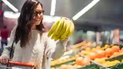 Woman shopping for bananas.