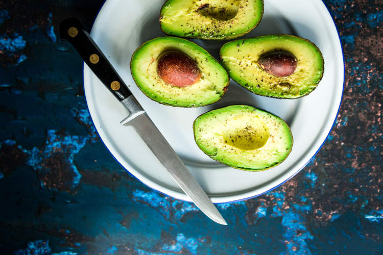 Cut avocados on a plate.