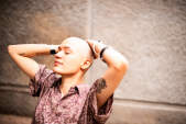 woman with bald head looking relaxed