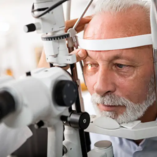 Senior man getting an eye exam from an optometrist.