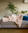 Woman on couch with blanket