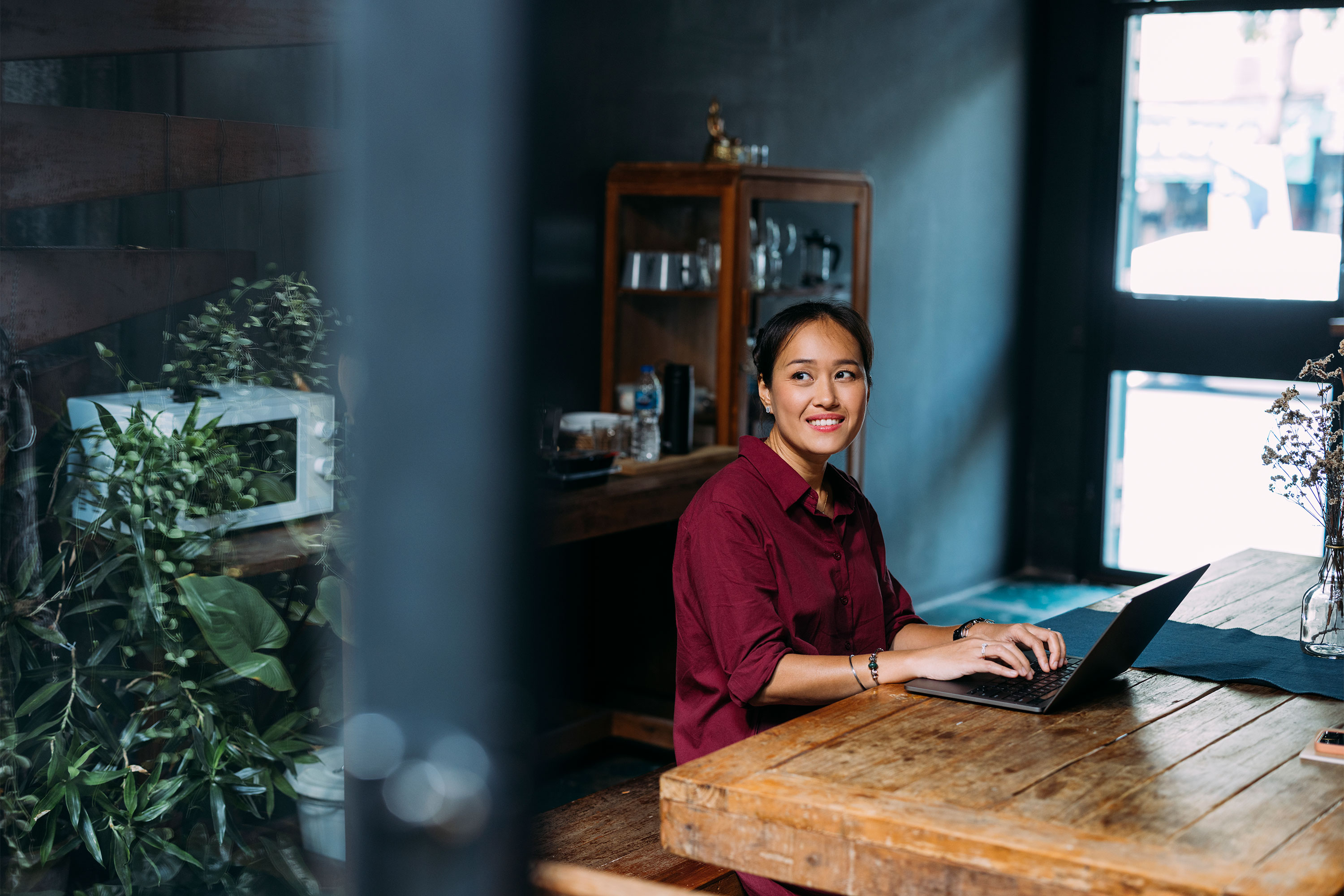 一位乐观的女士坐在家里的笔记本电脑前