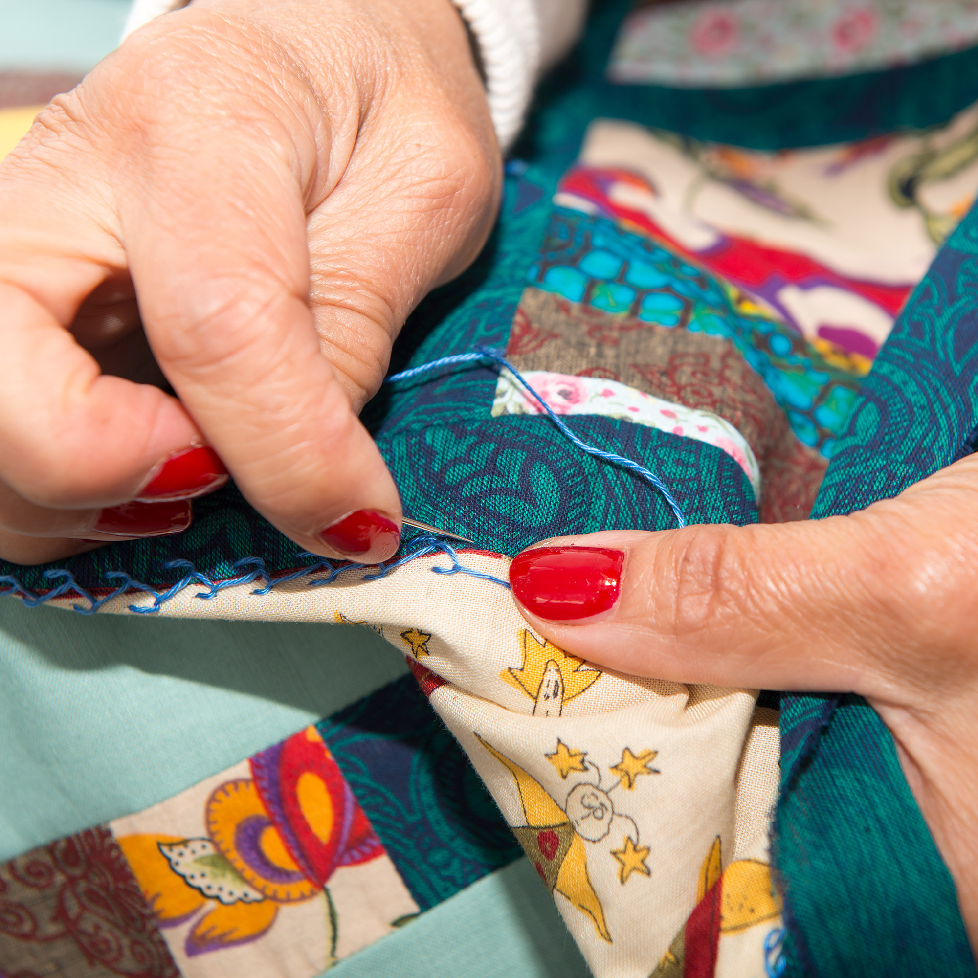 woman sewing for finish a quilt