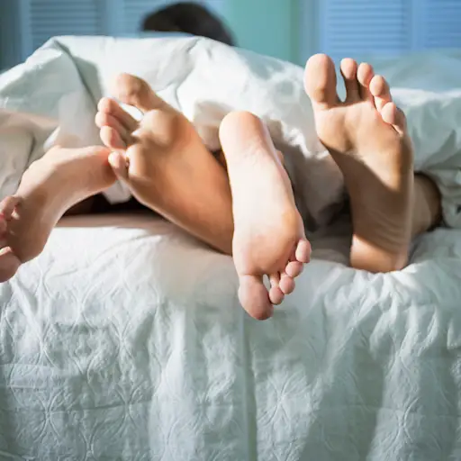 Young lovers under the covers in the morning