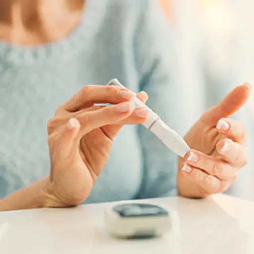 Woman measuring her blood sugar.