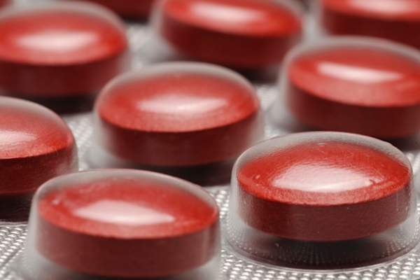 Close up of red iron pills in plastic packaging