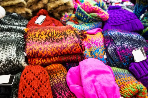 Colorful hats, gloves, and scarves for sale.