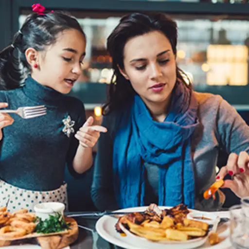 Mother and daughter at a restaurant.