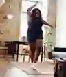 A woman dances alone at home