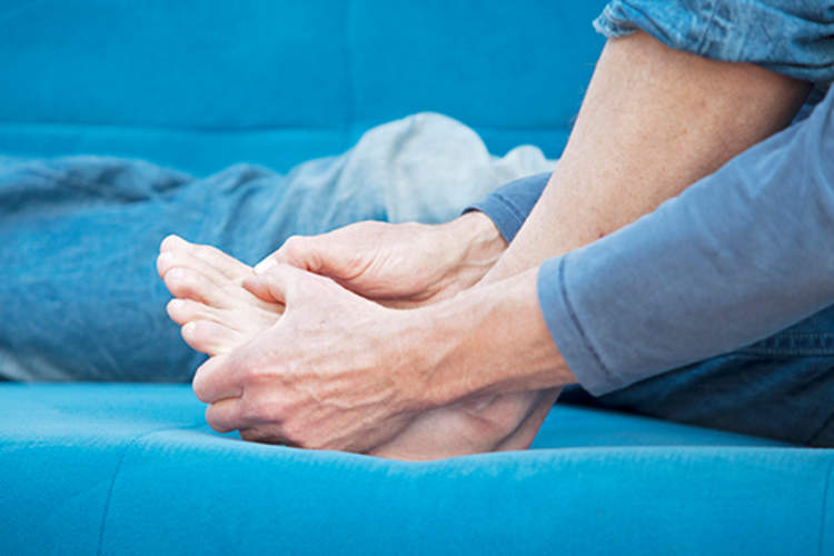 Man holding his foot.