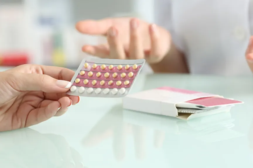 Woman buying contraceptive pills in a pharmacy.