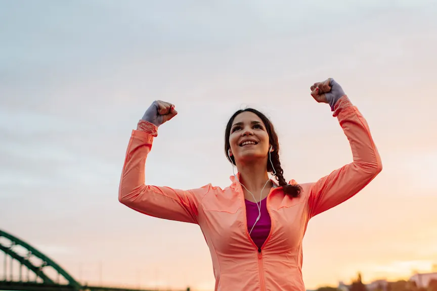 Athletic woman with her hands in the air