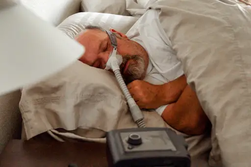 Man sleeping with a CPAP machine