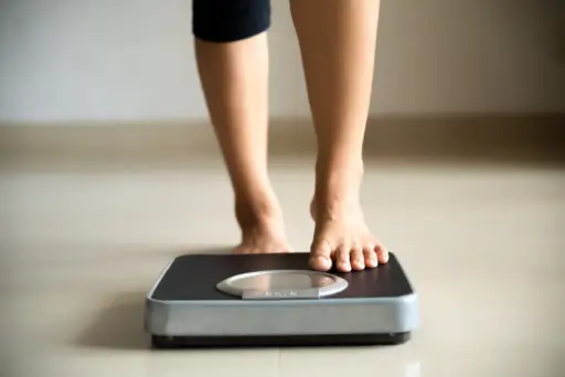 woman stepping onto scale