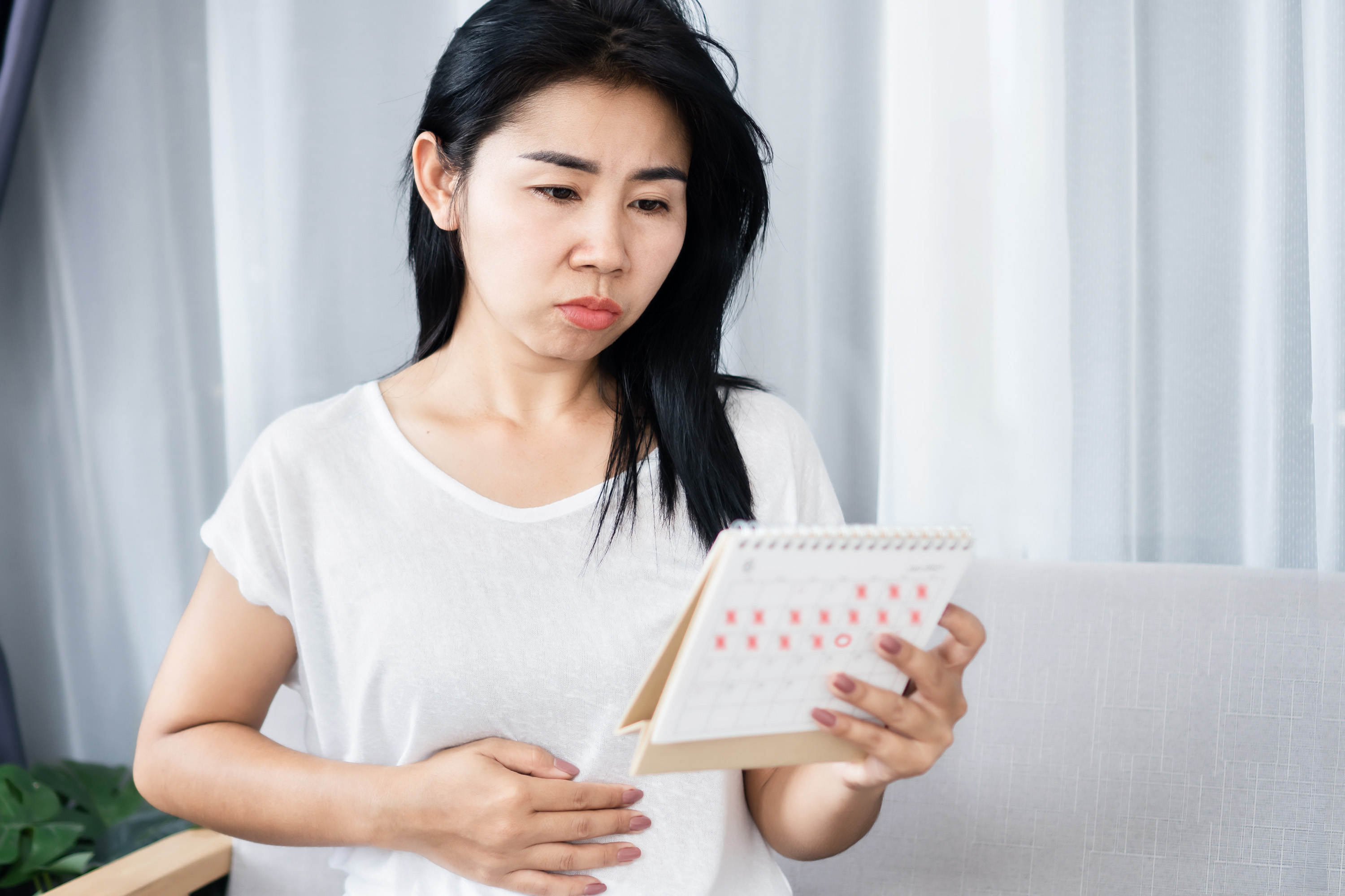 woman with missed period holding calendar 