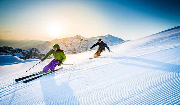 男人和女人滑雪下坡。
