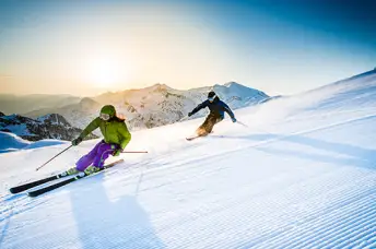男人和女人滑雪下坡。