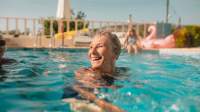 Senior woman smiling in pool