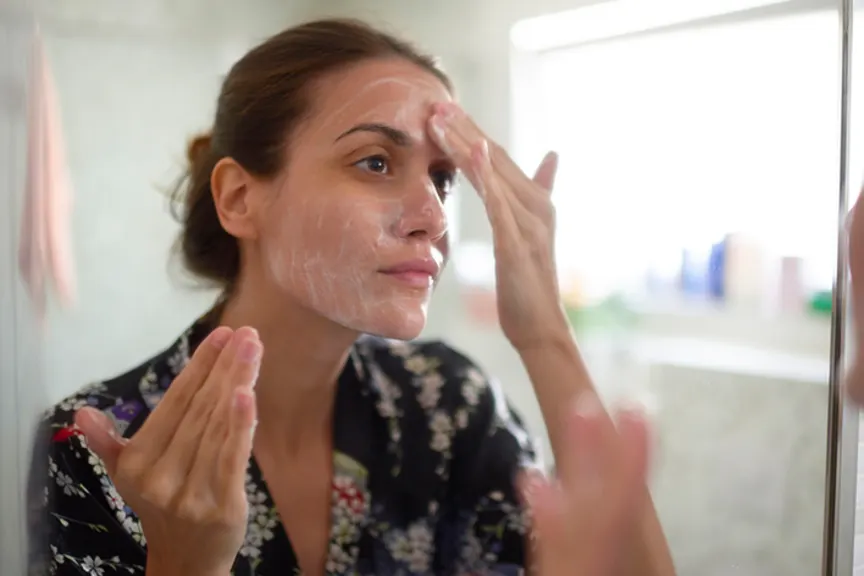 Woman using skin cream.