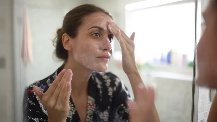 Woman using skin cream.