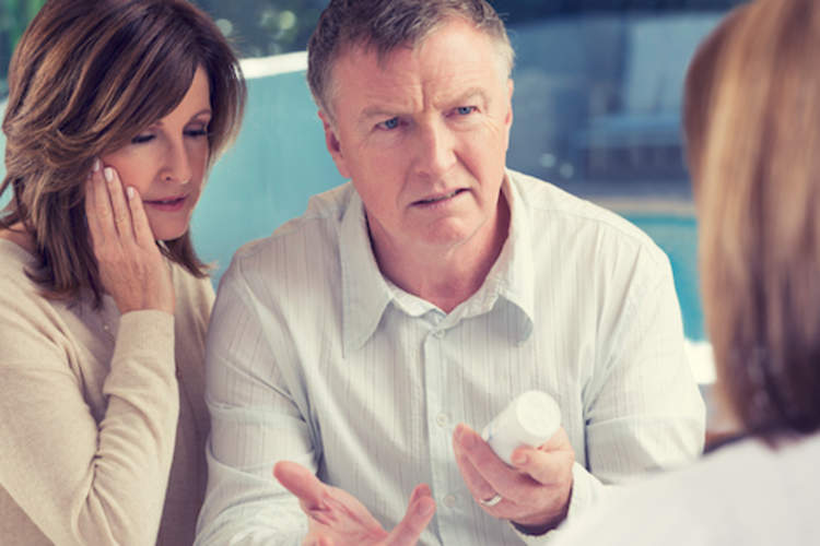 已婚夫妇与医生争论药物问题。