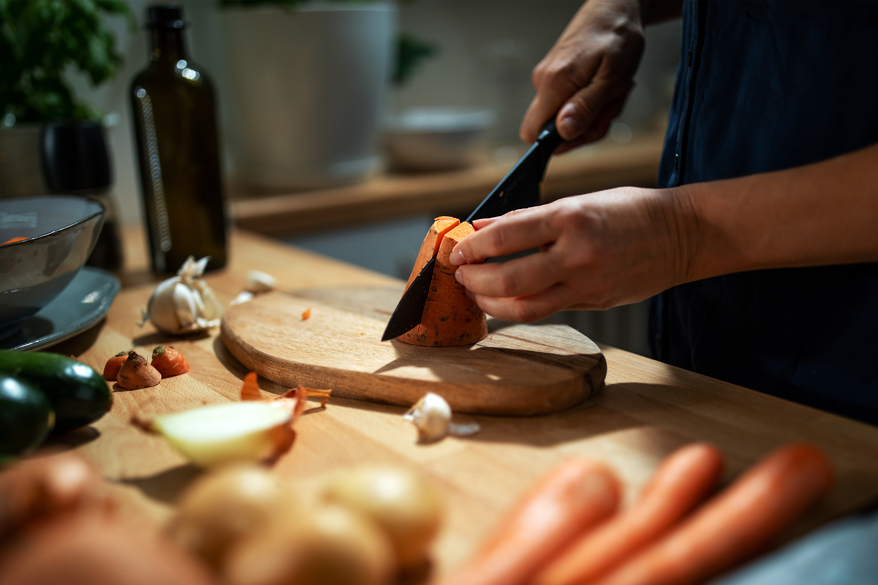 Hands preparing food in a kitchen, emphasizing dietary care while on medications.