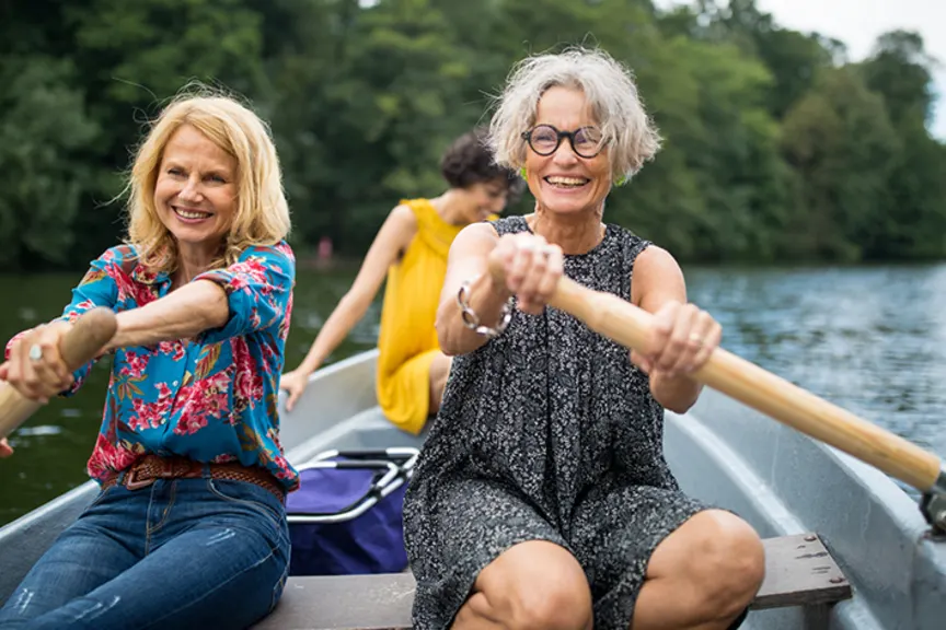 Seniors in a canoe laughing.