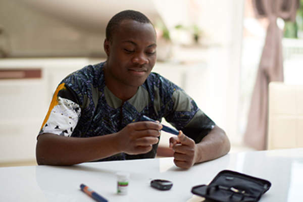 Man checking his blood glucose levels.