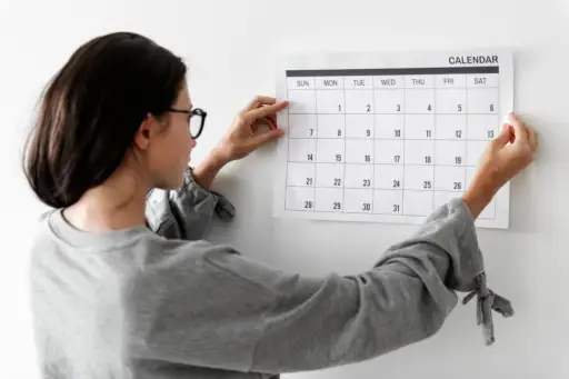 woman hanging calendar
