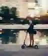 A man rides a scooter through a city