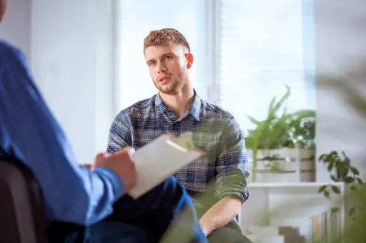 young man talking to therapist