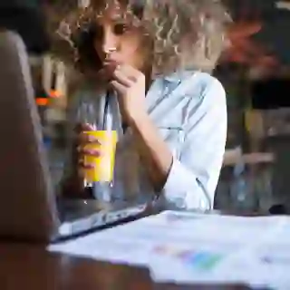 woman in cafe drinking orange juice