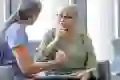 A woman listens to her doctor