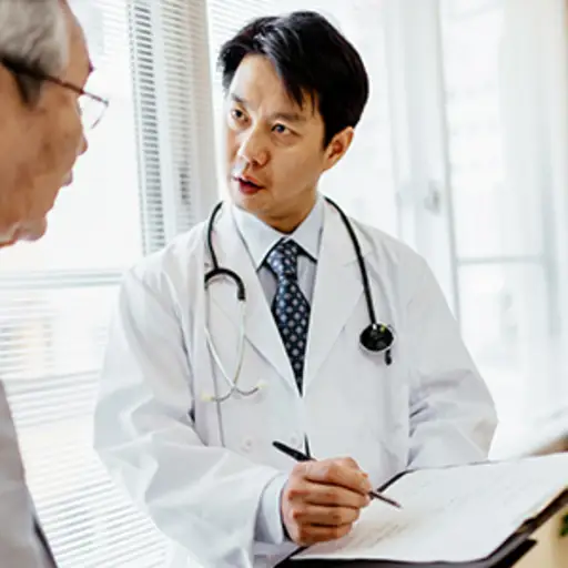 男医生向老年病人出示病历