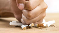 近距离的拳头粉碎香烟，停止吸烟的概念。
