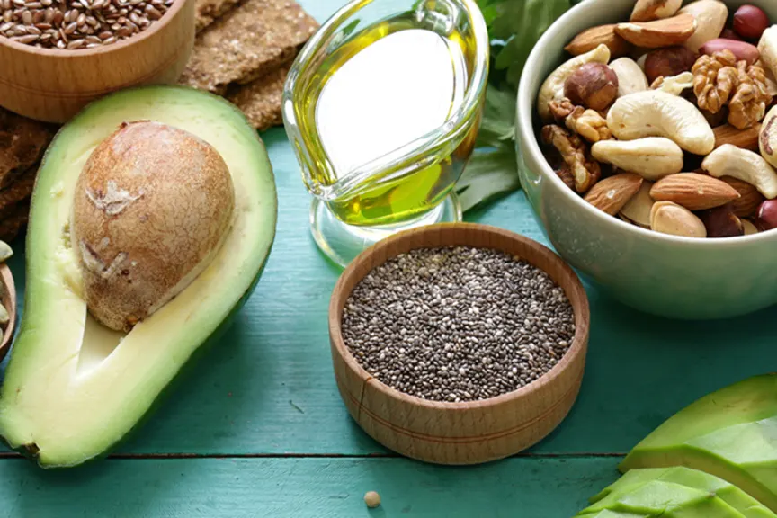 Healthy fats for people with crohn's disease including avocado, seeds, nuts, and olive oil.
