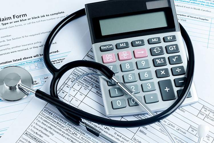 Rising health care costs, forms, stethoscope, and calculator.