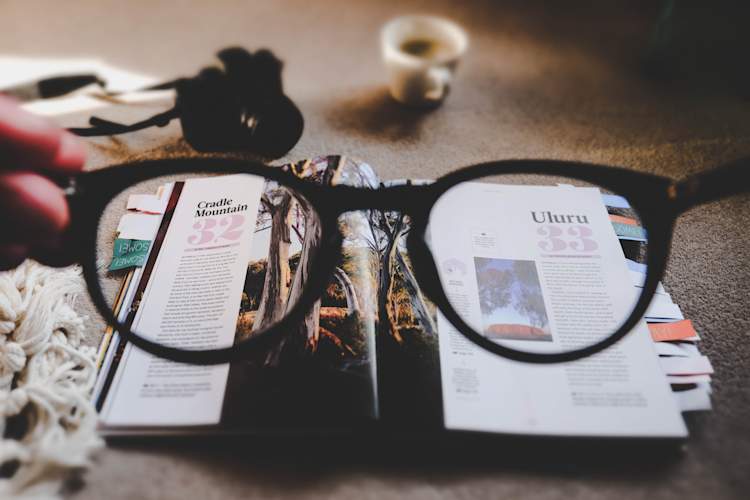 hands holding out glasses, clearing blurry tabletop view