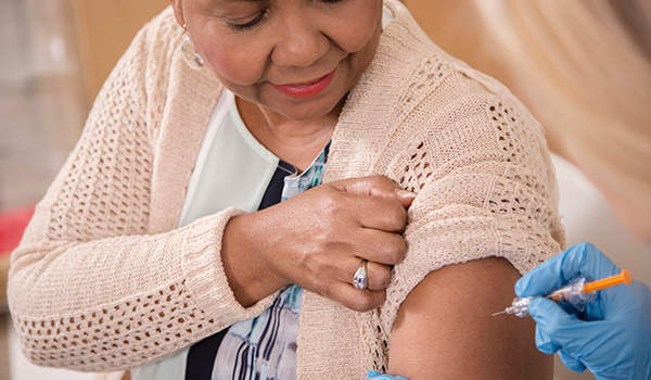 护士在门诊给老年病人接种流感疫苗