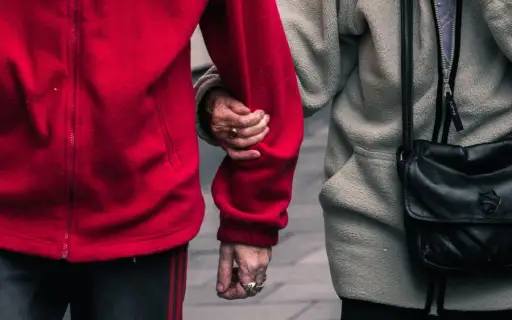 senior couple linking arms