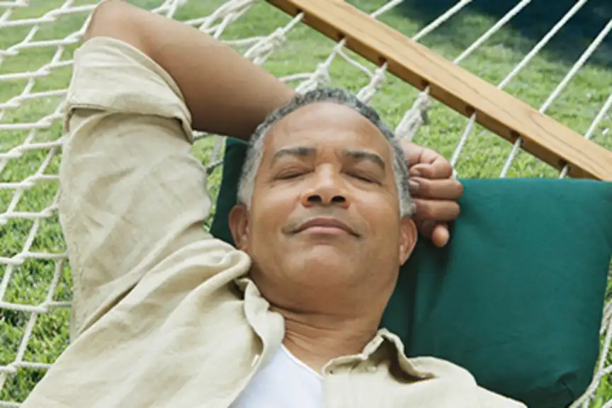 Senior man sleeping in hammock.