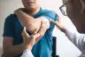doctor examining elbow